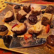 Photo of Green Door Cafe - La Jolla, CA, United States. The 'Ultimate' Carrot cake, Chocolate dipped macaroons, Lemon Tart, buttered scones with ham and cream