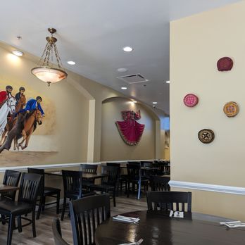 Kandahar Afghan Kitchen - a mural of a group of people riding horses - Afghan Near Me - Baltimore, Maryland