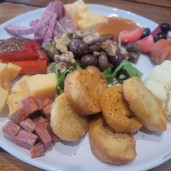 The Landing RoofTop - CHARCUTERIE & ARTISINAL CHEESE BOARD: Chef's choice of cheese and meats, pickled olives, jams, and crostinis. $19 - Comfort Food Near Me - Melbourne, Florida