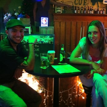 Irish Cue - a man and a woman sitting at a table - Pool Halls Near Me - Cornelius, North Carolina