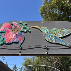 Archway art: Hummingbird and flower art over the walkway