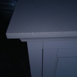 Menards - Brand New special order vanity. Chipped top in several areas, foot print inside cabinet, defects on doors.