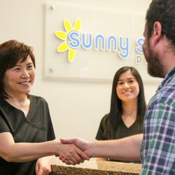 Sunny Smile Dental - Dr. Lee welcoming patient