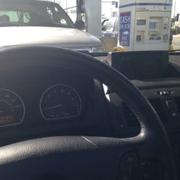 the dashboard of a car at a gas station