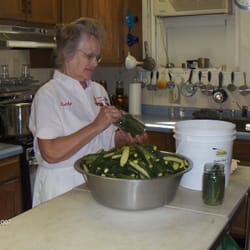 Kathy's Kitchen - Kathy hard at work hand packing cucumbers in jars.