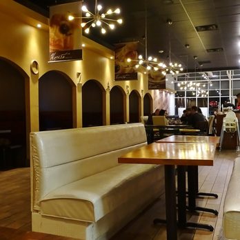Mozart Bakery - Row of dark booths on the left here in my photo actually contain customers! This angle you can't see bakery & coffee, etc at front area. - Bakeries Near Me - Carrollton, Texas