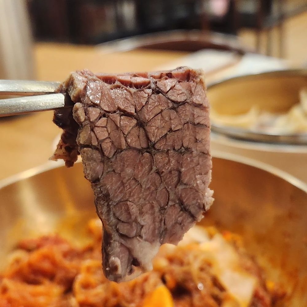 Homung Nangmyun - a piece of meat on a fork - Noodles Near Me - Fort Lee, New Jersey Homung Nangmyun - a piece of meat on a fork - Noodles Near Me - Fort Lee, New Jersey