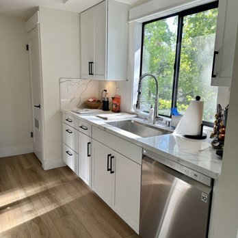 The Floor Store - a kitchen with white cabinets and a stainless steel dishwasher - Flooring Near Me - Dublin, California The Floor Store - a kitchen with white cabinets and a stainless steel dishwasher - Flooring Near Me - Dublin, California