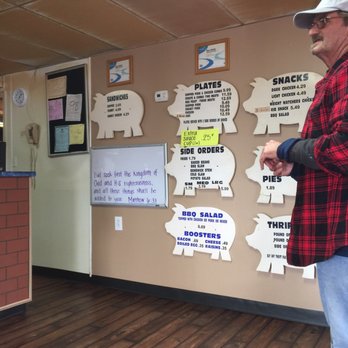 Chuck's Bar-B-Q - ows a man standing in front of a wall with signs on it - Barbeque Near Me - Valley, Alabama