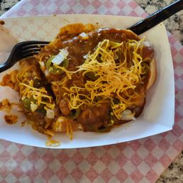 Super dog with chili, relish, onions, jalapeños and cheese. Super dog with chili, relish, onions, jalapeños and cheese.