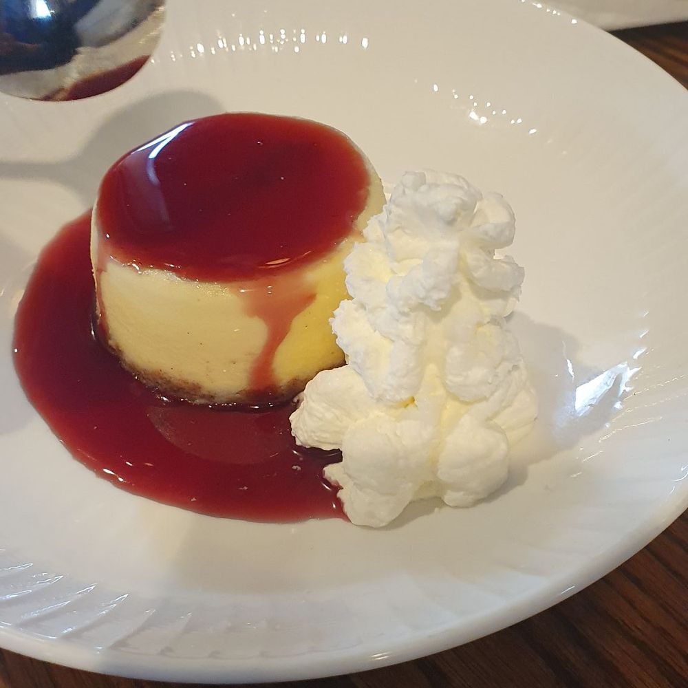 Dockside Pub - The cheescake with rasberry sauce. So yummy and she couldn't wait to dig in, hence the spoon. - Bars Near Me - Swampscott, Massachusetts