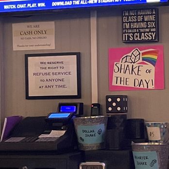 The Revival - a bar with a tv and a sign - Cocktail Bars Near Me - Stoughton, Wisconsin