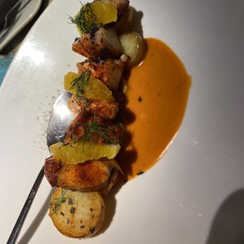 Entre Santos - Spicy octopus arm with potatoes - Cocktail Bars Near Me - Madrid, M Entre Santos - Spicy octopus arm with potatoes - Cocktail Bars Near Me - Madrid, M
