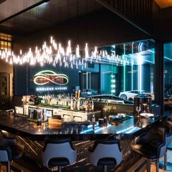 Driven Steakhouse - The Driven Steakhouse bar, looking into the Endless Garage showroom