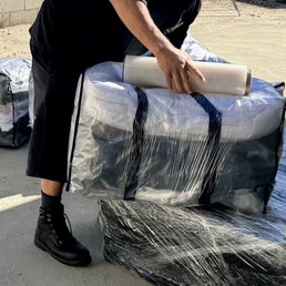 Securely wrapping our moving bags for more added security. Securely wrapping our moving bags for more added security.