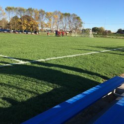 Sitting in stands to watch a soccer match.
