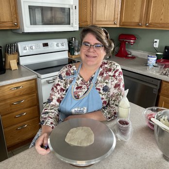 Kim E’s Cakery - a woman in a kitchen preparing a cake - Custom Cakes Near Me Kim E’s Cakery - a woman in a kitchen preparing a cake - Custom Cakes Near Me