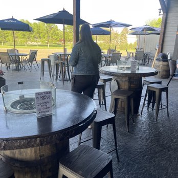 The Train Station - people sitting at tables with umbrellas - Burgers Near Me - Alton, Iowa