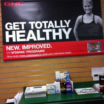 GNC - a woman standing in front of a sign that says get totally healthy - Health Markets Near Me - Santa Ana, California GNC - a woman standing in front of a sign that says get totally healthy - Health Markets Near Me - Santa Ana, California