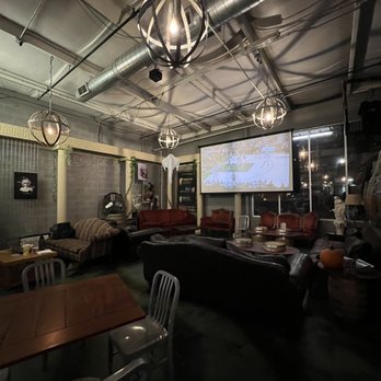 Akademia Brewing Company - a large room with couches, tables, and a projector screen - Brewpubs Near Me - Athens, Georgia Akademia Brewing Company - a large room with couches, tables, and a projector screen - Brewpubs Near Me - Athens, Georgia