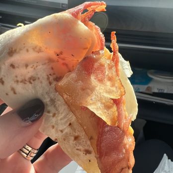 Dunkin' - a person holding a piece of pizza - Donuts Near Me - Denver, Pennsylvania Dunkin' - a person holding a piece of pizza - Donuts Near Me - Denver, Pennsylvania
