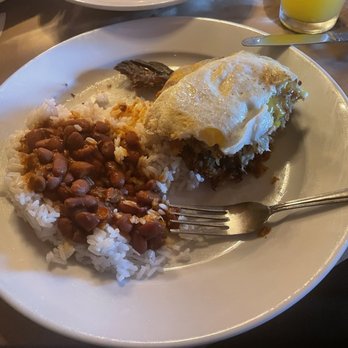 Rice and Beans - Pionono Mashed sweet plantain filled with savory ground beef topped with melted cheese and a fried egg. Red beams and white rice. - Puerto Rican Near Me - Wesley Chapel, Florida