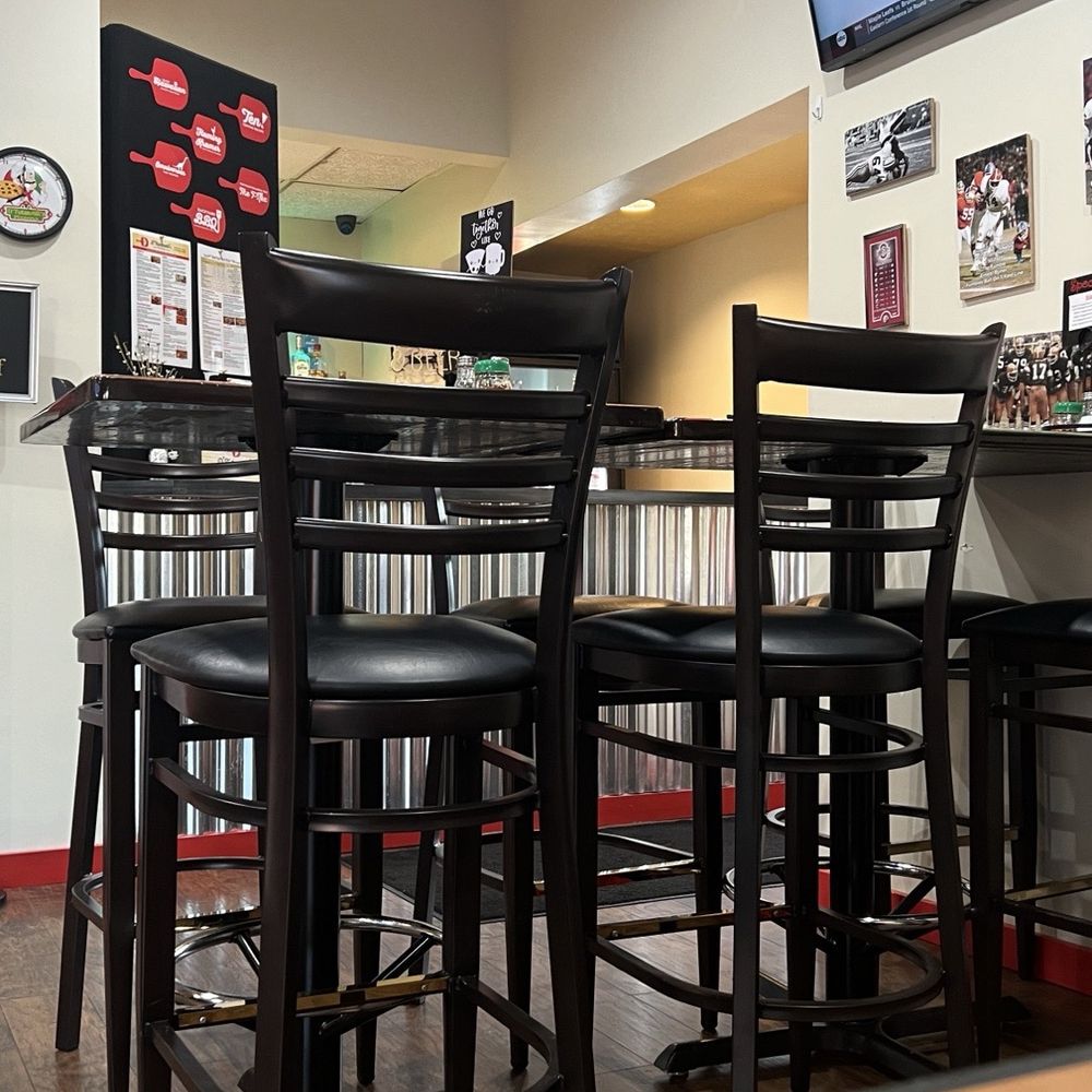 D'Tutanelli's Pizza - This is inside, behind that table is the carry out counter.  There are multiple tv screens in the restaurant. - Pizza Near Me - Amherst, Ohio