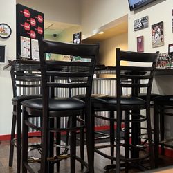 D'Tutanelli's Pizza - This is inside, behind that table is the carry out counter. There are multiple tv screens in the restaurant.