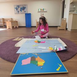Guidepost Montessori at Downtown Naperville - My daughter assembling her own map of the world through research, puzzles and images