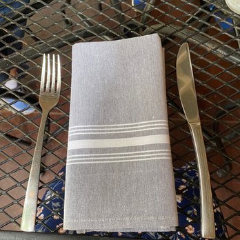 Grit - a fork, knife and napkin on a table - New American Near Me - Oxford, Mississippi