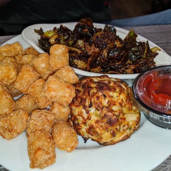 Skipjack's - Single broiled crab cake w tater tots and Brussels sprouts - Seafood Near Me - Nottingham, Maryland