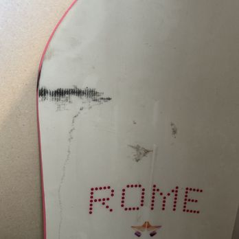 Dose Moving and Storage - A mirror with visible scratches and dirt, displaying the word 'ROME' in red dots and a small decorative element at the bottom. - Movers Near Me - Phoenix, Arizona