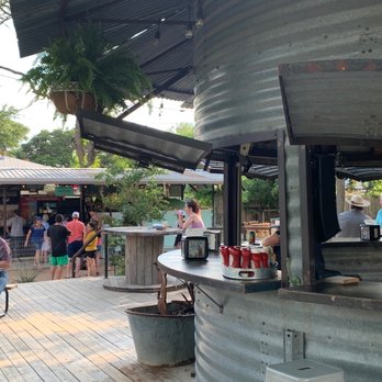 Hippie Chic's River Shack - Patio between Hippie Chic's and Hippies Gypsies & Hops (bar and pizza ordering is that line on the left) - American Near Me - Concan, Texas