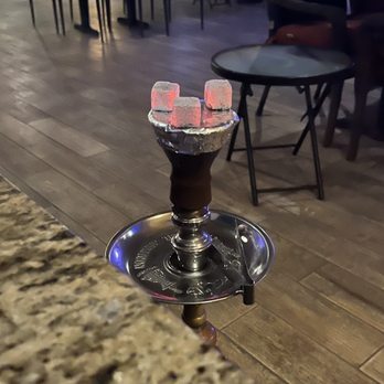 Hookah and More - a glass of wine on a table - Hookah Bars Near Me - Miami, Florida
