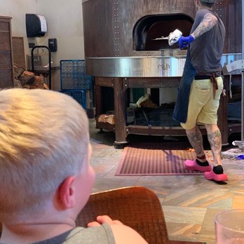 Hand Fire Pizza - Pizza going into the wood fire oven. - Pizza Near Me - Jackson, Wyoming