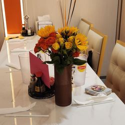 Golden Apple Buffet - Table with flowers for a small Birthday gathering.