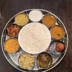 Nandini - Veg thali. 2 dal, raita, pickle, potato fry, sambar, rasam, veg biryani, gulan jamun. Not in pic (2 chapati, papad, vada)