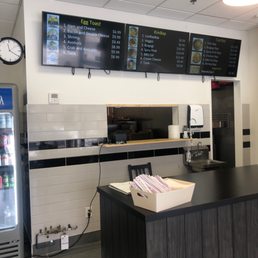 The menu board - Three digital menu screens show food options and prices at LooBapBap in Waterloo, ON, including egg toast, KimBap, and Cup Bap.