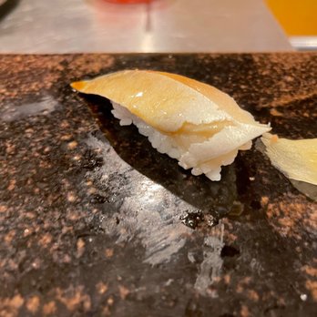 Sushi Uesugi - a piece of sushi on a cutting board - Sushi Bars Near Me - Brooklyn, New York Sushi Uesugi - a piece of sushi on a cutting board - Sushi Bars Near Me - Brooklyn, New York