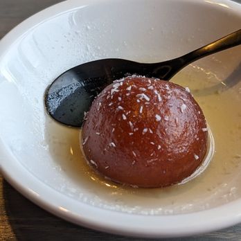 Oh Bombay - a bowl of food with a spoon in it - Indian Near Me - Richmond Hill, Ontario