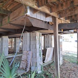 Specialty Home Inspections - Unsafe building practices. This is a trailer/modular home lifted of the ground.