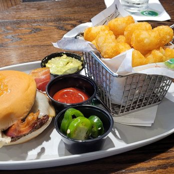 Wahlburgers - BBQ Bacon Burger with jalapeños and avocado spread with tater tots. - Burgers Near Me - Cleveland, Ohio Wahlburgers - BBQ Bacon Burger with jalapeños and avocado spread with tater tots. - Burgers Near Me - Cleveland, Ohio