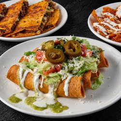 Fuego Cravings - Crispy potato tacos topped with fresh toppings, with a cheesy birria quesadilla in the back!