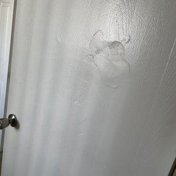 The Perch on 52nd - Someone or something has punched/run in to the door and instead of replacing the cheap door they do a shitty repatch job - Apartments Near Me - Arvada, Colorado