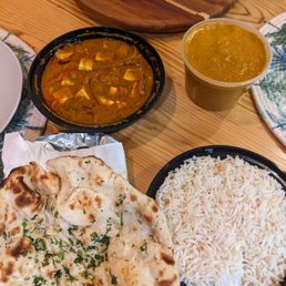 garlic naan, lamb coconut korma, and kadhai paneer