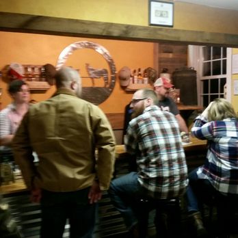 Cart/Horse Distilling - a group of people sitting at a bar - Distilleries Near Me - Edinboro, Pennsylvania