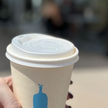 Blue Bottle Coffee - Malibu - a hand holding a coffee cup - Coffee & Tea Near Me - Malibu, California Blue Bottle Coffee - Malibu - a hand holding a coffee cup - Coffee & Tea Near Me - Malibu, California
