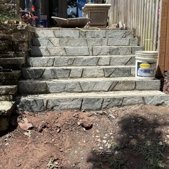 Mottern Masonry Design - Steps from raised stone platform patio to ground level. - General Contractors Near Me - Vienna, Virginia Mottern Masonry Design - Steps from raised stone platform patio to ground level. - General Contractors Near Me - Vienna, Virginia