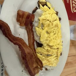 Home fries, sausage gravy, scrambled eggs with a side of bacon.