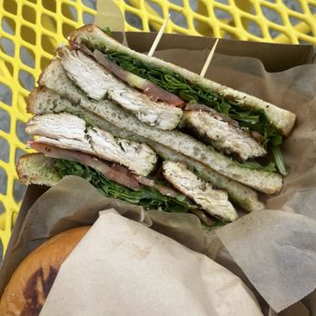Dwight's Beach Concession - Chicken pesto sandwich with arugula and sourdough bread - Bike Rentals Near Me - Huntington Beach, California